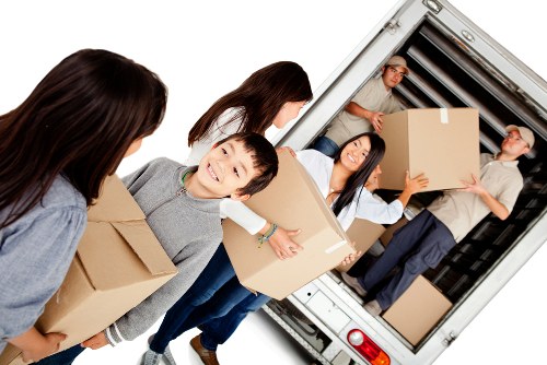 Planning home moves in Lee with moving boxes and a house in the background