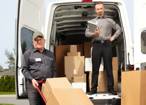 Removal company van and moving team in Lee preparing for a home relocation