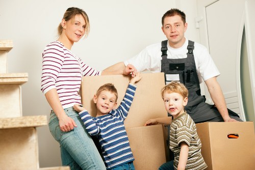 Professional movers in Lee packing boxes and household items