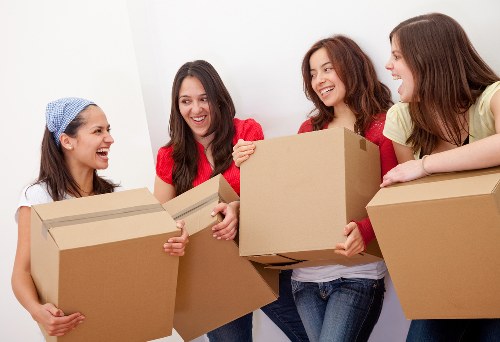 Home furniture removals in Lee showing a team moving sofas and tables