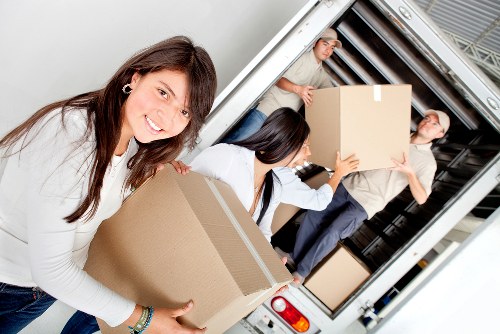Careful piano transport through a narrow stairway in a Lee property
