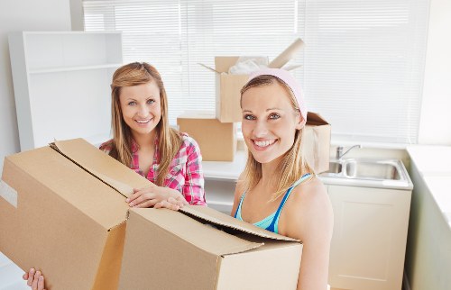 Professional removal van in Lee loading packed boxes