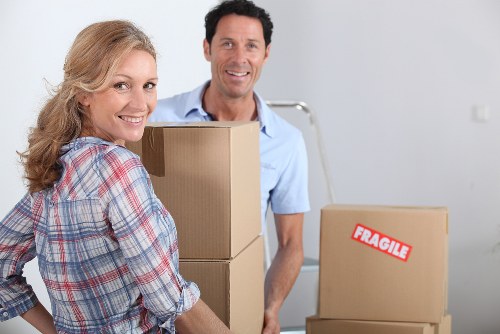 A moving team placing furniture into rooms during a house removal in Lee