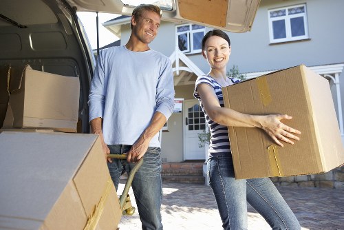 Piano movers navigating stairs during a removal in Lee